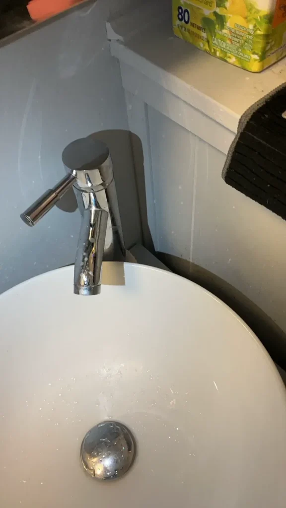New bathroom sink faucet installed and sealed