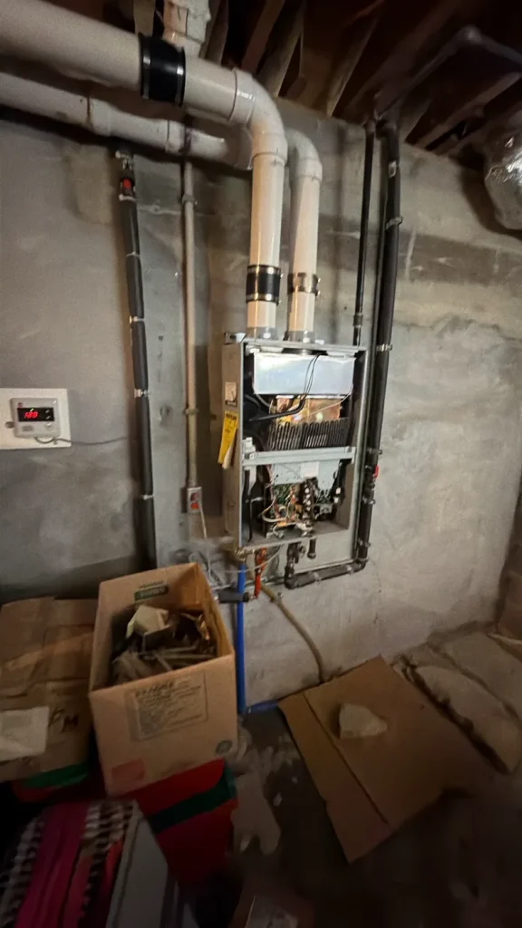 Tankless water heater serviced with the front panel opened